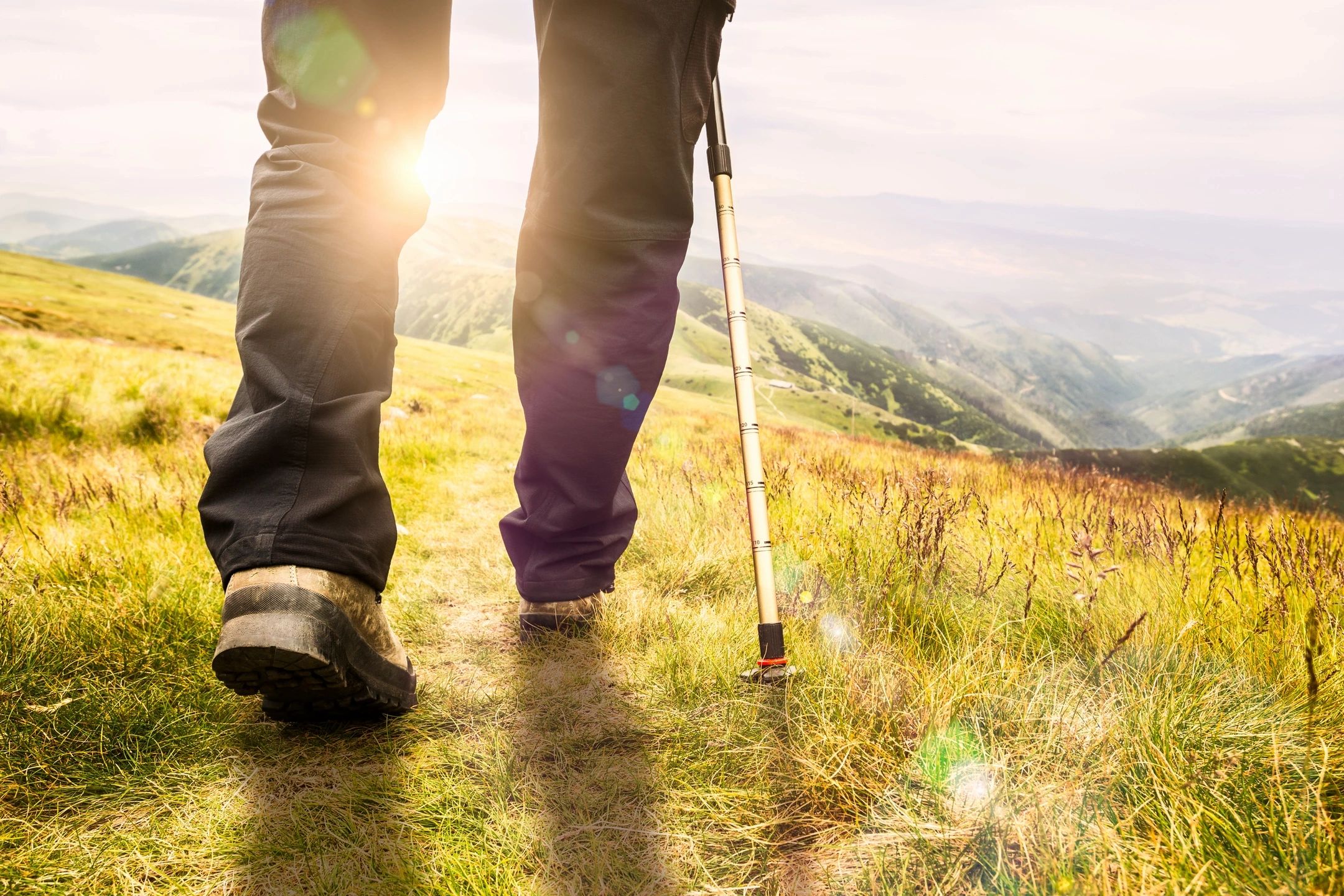 hiking over a sun drenched hill