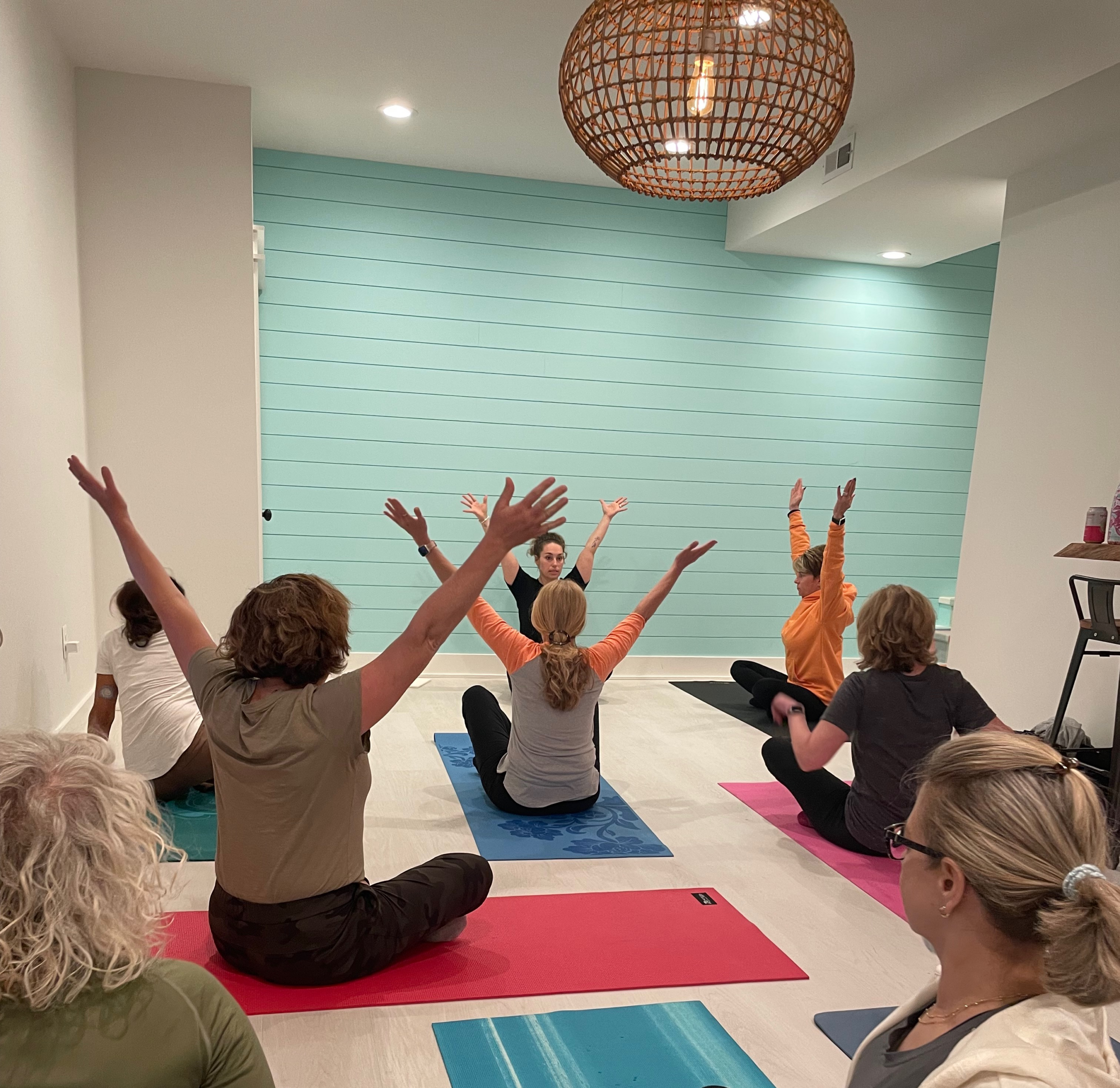 A group of women participate in yoga